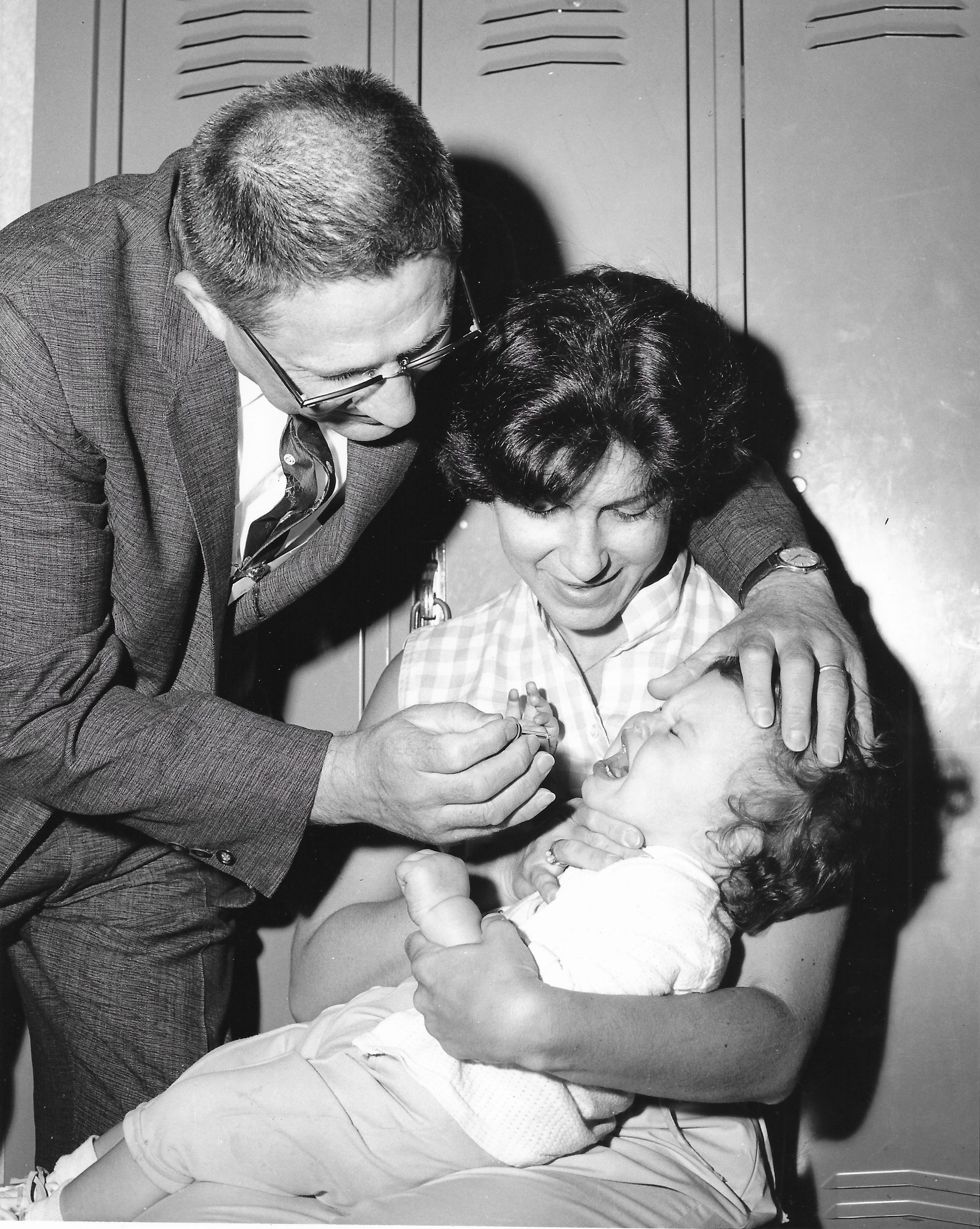 Mrs. Daniel Weckstein helps her one year old daughter Karen receive the vaccine.