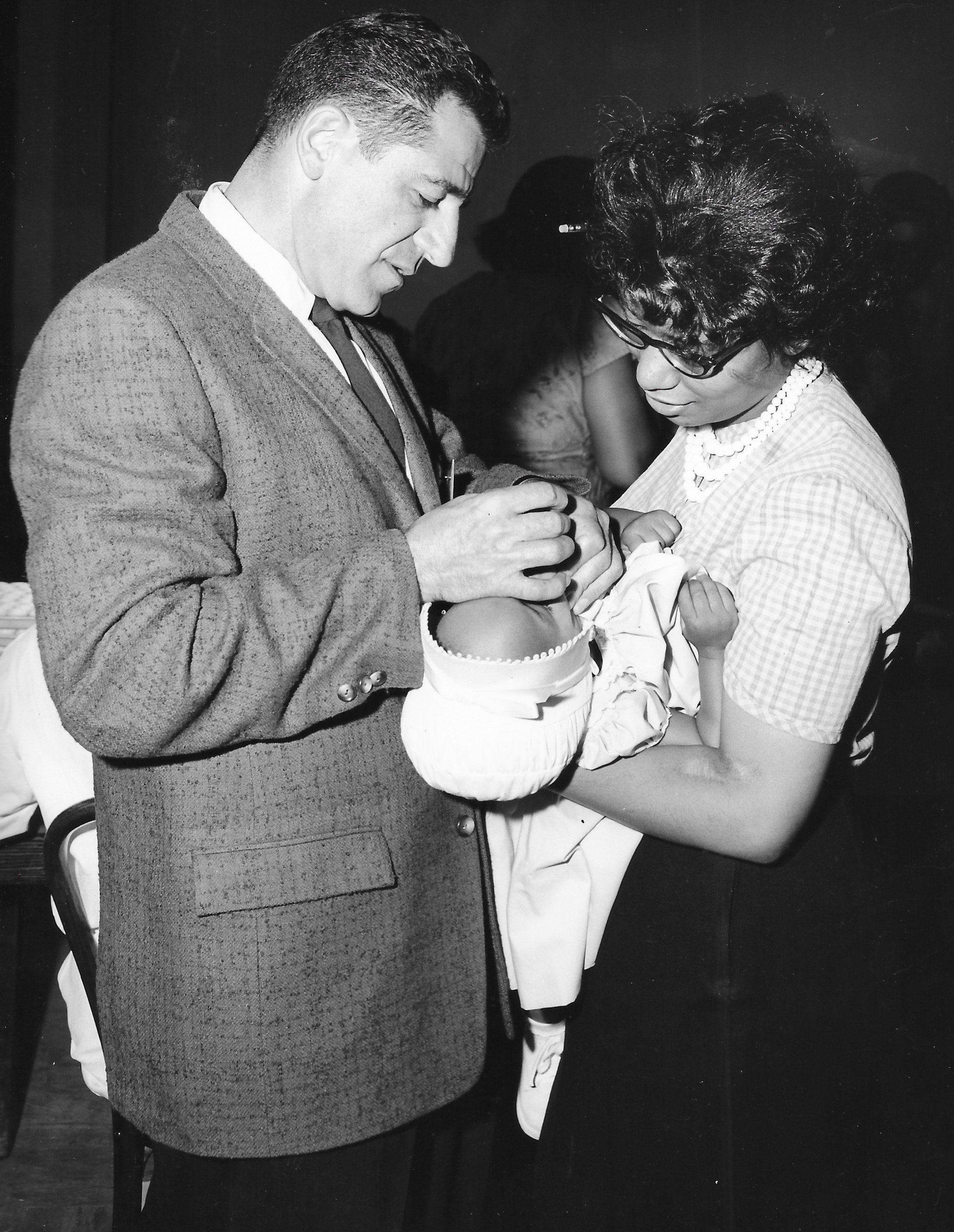 Dr. Robert Rogoff administers Sabin Oral Vaccine to baby Lecia Lynn Carter